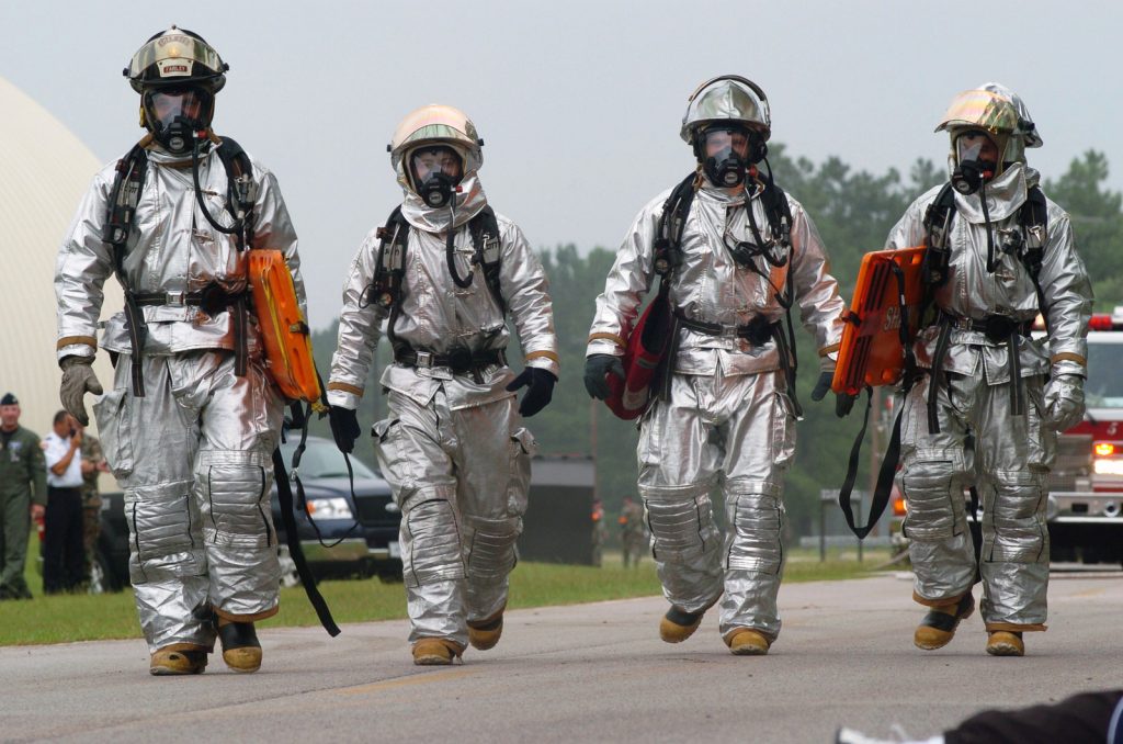 US Air Force (USAF) Firefighters, 20th Civil Engineering Squadron (CES), Shaw Air Force Base (AFB), South Carolina (SC), respond in Joint Firefighter Integrated Response Ensembles (JFIRE) in Mission Oriented Protective Posture (MOPP) 4 to a major accident response exercise (MARE) scenario on Patrol Road at the base. Emergency response agencies on the base are participating in a scenario involving a fuel spill and casualties.